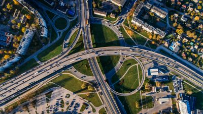 An overhead view of a highway interchange. Image courtesy Pexels.